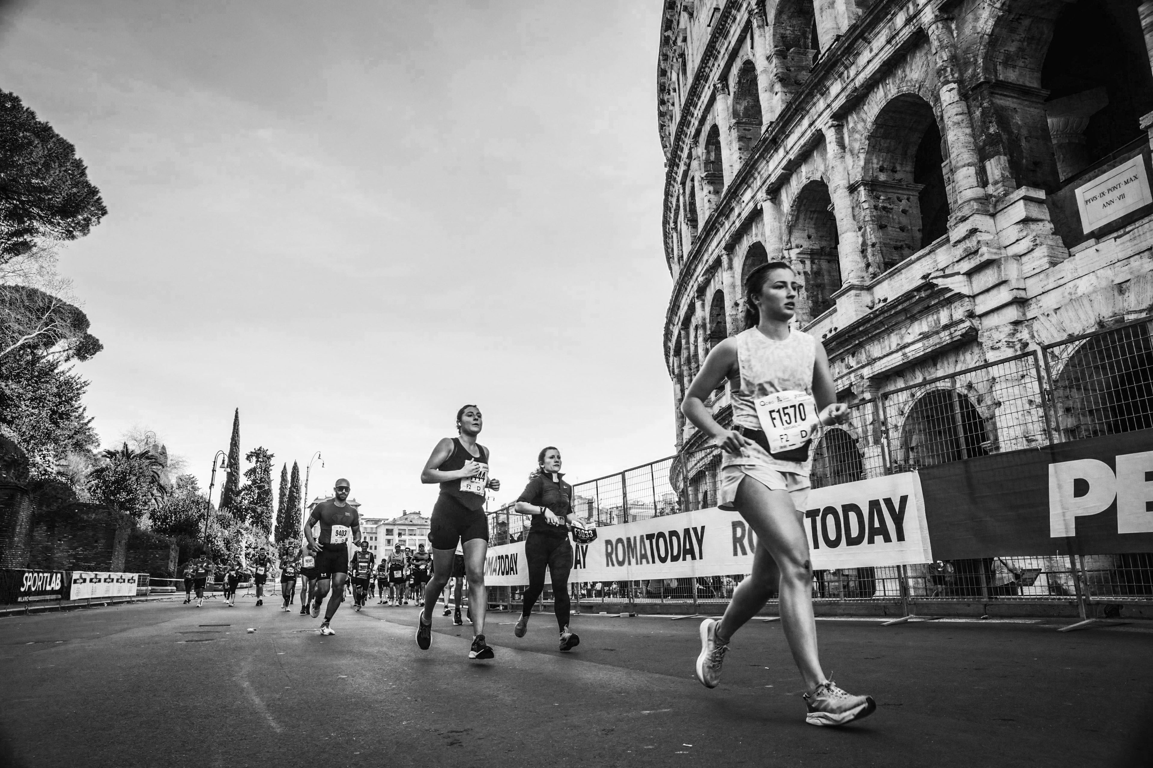 Runners participating in a marathon with the Colosseum in the background